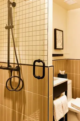 a bathroom with a refrigerator and a sink at Union Hotel in Toronto