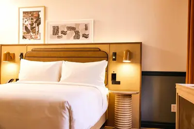 a hotel room with a bed with white sheets at Union Hotel in Toronto