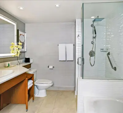a bathroom with a shower and a toilet and a sink at Crowne Plaza Toronto - North York by IHG in Toronto