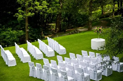 a row of white chairs and a table with flowers at Crowne Plaza Toronto - North York by IHG in Toronto