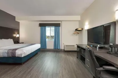 a hotel room with a bed and a flat screen tv at Comfort Hotel in Niagara Falls