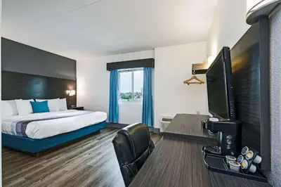 a hotel room with a bed and a flat screen tv at Comfort Hotel in Niagara Falls