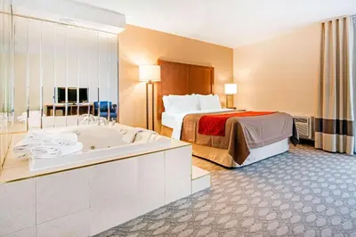 a hotel room with a bed and a bath tub at Comfort Inn Fallsview in Niagara Falls