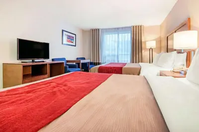 a hotel room with two beds and a flat screen tv at Comfort Inn Fallsview in Niagara Falls