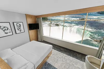 a room with a couch and a view of a waterfall at Tower Hotel at Fallsview in Niagara Falls