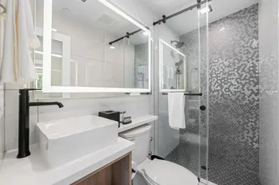 a bathroom with a shower and a toilet and a sink at Tower Hotel at Fallsview in Niagara Falls