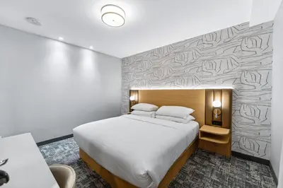 a hotel room with a bed and a wall at Tower Hotel at Fallsview in Niagara Falls