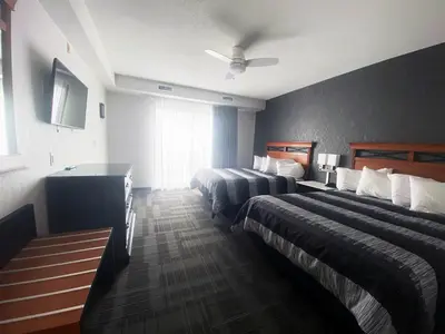 a hotel room with two beds and a ceiling fan at Americana Waterpark Resort & Spa in Niagara Falls