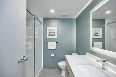 a bathroom with a toilet and a sink and a shower at Vittoria Hotel & Suites in Niagara Falls