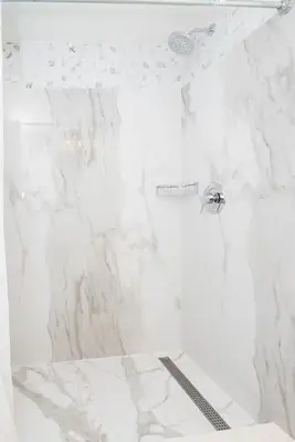 a bathroom with a white marble shower stall at Diplomat Inn in Niagara Falls