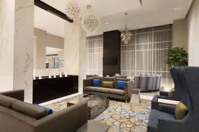 a lobby with couches and chairs and a fireplace at Embassy Suites By Hilton Toronto Airport in Toronto
