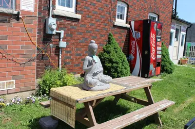 a statue of a woman sitting on a picnic table at Ritz Inn Niagara in Niagara Falls