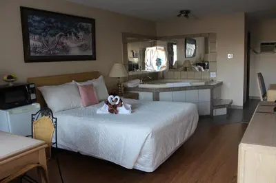 a bedroom with a bed with a stuffed animal on it at Ritz Inn Niagara in Niagara Falls