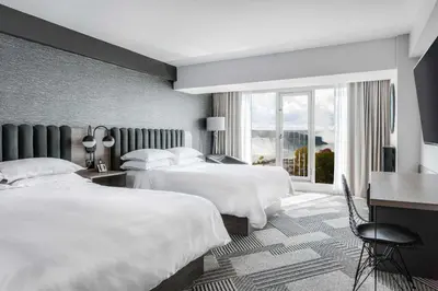 a hotel room with two beds and a window at Sheraton Fallsview Hotel in Niagara Falls