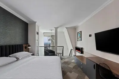 a hotel room with a bed and a flat screen tv at Sheraton Fallsview Hotel in Niagara Falls