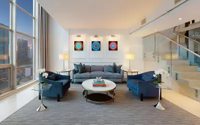 a living room with a couch and a table at SoHo Hotel Toronto in Toronto
