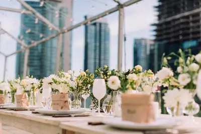 a long table with white flowers in glass vases at SoHo Hotel Toronto in Toronto
