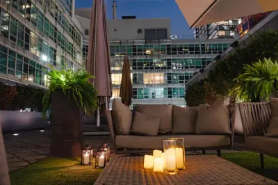 a patio with a couch and candles on a table at SoHo Hotel Toronto in Toronto
