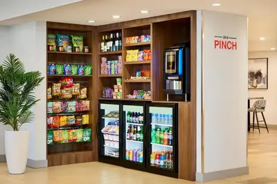a grocery store with a refrigerator with drinks at TownePlace Suites by Marriott Mississauga-Airport Corporate Centre in Mississauga