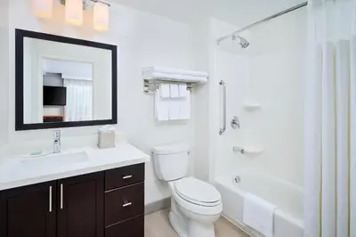 a bathroom with a toilet and a sink and a tub at TownePlace Suites by Marriott Mississauga-Airport Corporate Centre in Mississauga