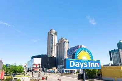 a day inn sign in front of a city at Days Inn by Wyndham Fallsview in Niagara Falls