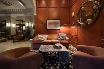 a living room with a couch and a table at Hotel Victoria in Toronto