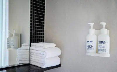 a pile of towels on a shelf in a bathroom at Hotel Victoria in Toronto