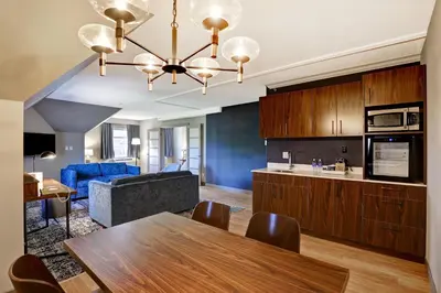 a kitchen and living room with a table and a couch at Four Points by Sheraton St. Catharines Niagara Suites in Thorold