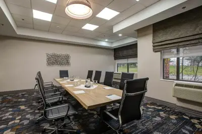 a conference room with a large table and chairs at Four Points by Sheraton St. Catharines Niagara Suites in Thorold