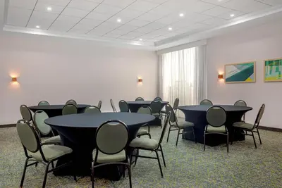 a conference room with tables and chairs in it at Spark by Hilton Toronto Airport in Toronto