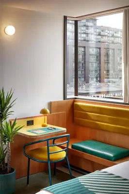 a room with a table and a chair and a window at The Drake Hotel in Toronto