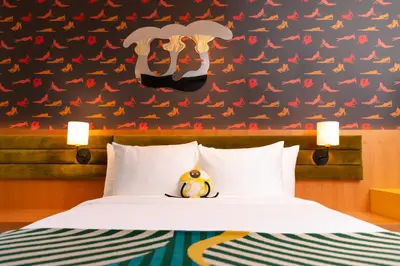 a bedroom with a bed and a black wall with birds at The Drake Hotel in Toronto
