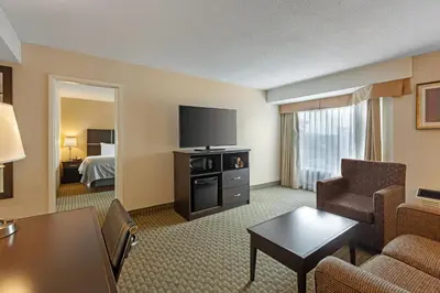 a hotel room with a living room with a bed at Quality Inn & Suites in Brampton