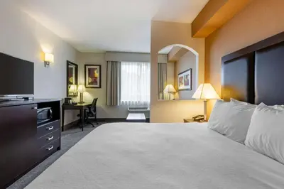 a hotel room with a bed and a desk at Best Western Plus Burlington Inn & Suites in Burlington