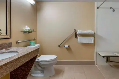 a bathroom with a toilet and a sink at Best Western Plus Burlington Inn & Suites in Burlington