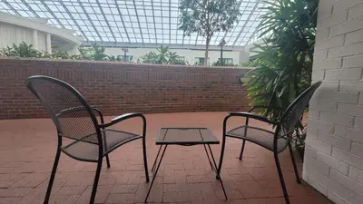 two chairs and a table on a patio at Best Western Plus Lamplighter Inn & Conference Centre in London