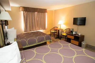 a hotel room with a bed and a flat screen tv at Super 8 by Wyndham Mississauga in Mississauga