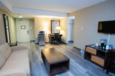 a living room with a couch and a table at Super 8 by Wyndham Mississauga in Mississauga