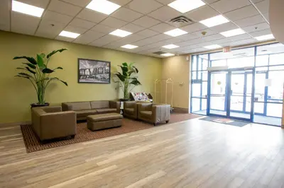 a waiting room with couches and chairs in a building at Super 8 by Wyndham Mississauga in Mississauga