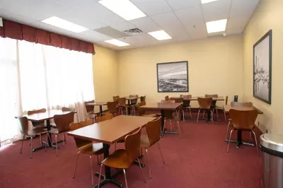 a classroom with tables and chairs in a room at Super 8 by Wyndham Mississauga in Mississauga