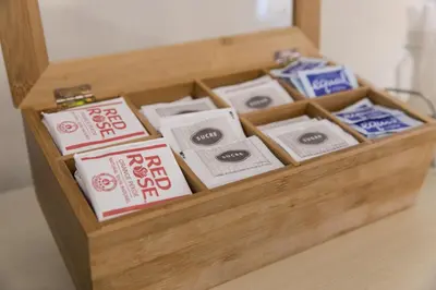a wooden box filled with packets of toothpaste at Days Inn by Wyndham Toronto West Mississauga in Mississauga