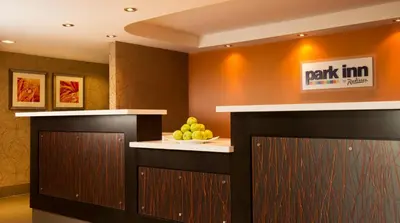 a lobby with a counter with a bowl of fruit at Park Inn by Radisson Toronto-Markham in Markham