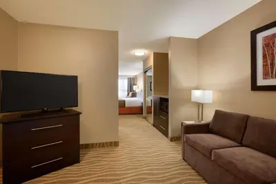 a living room with a couch and a flat screen tv at Park Inn by Radisson Toronto-Markham in Markham