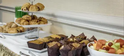 a table topped with different types of pastries and bread at Monte Carlo Inn Brampton in Brampton