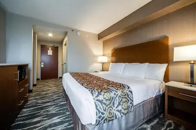 a hotel room with a large bed in a room at Monte Carlo Inn Brampton in Brampton