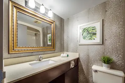 a bathroom with a sink and a mirror at Monte Carlo Inn Airport Suites in Mississauga