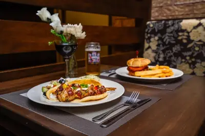 a table with two plates of food and a sandwich at Monte Carlo Inn Airport Suites in Mississauga