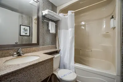 a bathroom with a sink and a toilet and a shower at Monte Carlo Inn Toronto West Suites in Mississauga