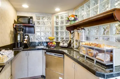 a kitchen with a counter with some food on it at Monte Carlo Inn Toronto West Suites in Mississauga