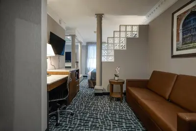 a living room with a couch and a desk at Monte Carlo Inn Toronto West Suites in Mississauga